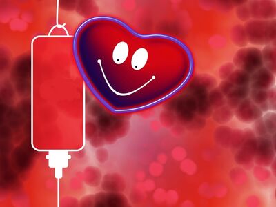 Blutspende in Altötting, Kultur+Kongress Forum Altötting, Foto Blutspendedienst Stilisierte Bluttropfen und davon ein Herz mit Smiley-Gesicht.