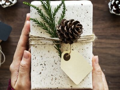 Eine Frau überreicht ein Geschenk.  