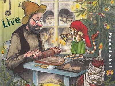 Ein alter Mann und ein Kater sitzen an einem Tisch.