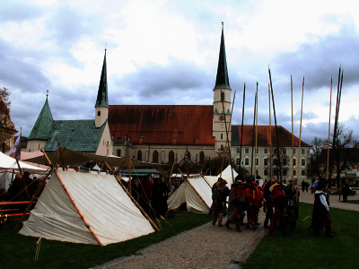 Zelte und kostümierte Menschen im Mittelalteroutfit am Kapellplatz Altötting. 