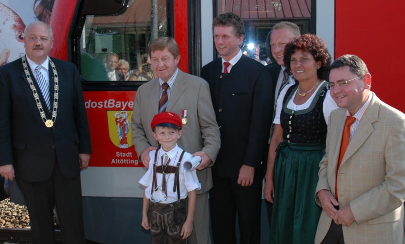 Ehrengäste Altöttings stehen vor dem getauften Zug.