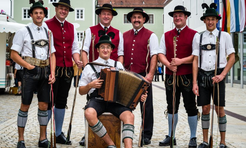 Gruppenfoto von Trachtlern mit einer Ziehharmonika. 